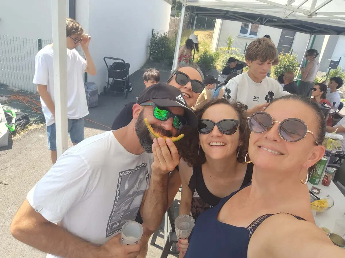 Voisins souriants réunis pour une photo pendant la fête.